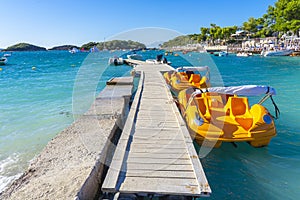 jetty for pleasure boats in the crystal-clear bathing area of Ã¢â¬â¹Ã¢â¬â¹Bora Bora beach in Ksamil, Albania.